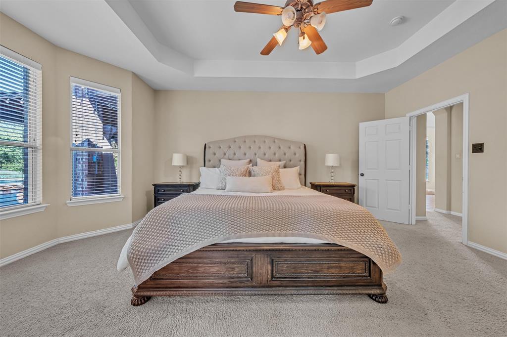 437 Rusty Run Drive Midlothian, TX 76065 - Photo 21 of 40 a bedroom with a bed and a chandelier