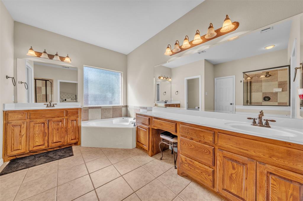 437 Rusty Run Drive Midlothian, TX 76065 - Photo 22 of 40 a spacious bathroom with a granite countertop sink mirror and bathtub