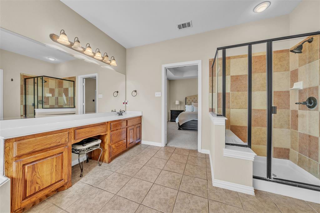 437 Rusty Run Drive Midlothian, TX 76065 - Photo 23 of 40 a spacious bathroom with a granite countertop sink mirror and bathtub