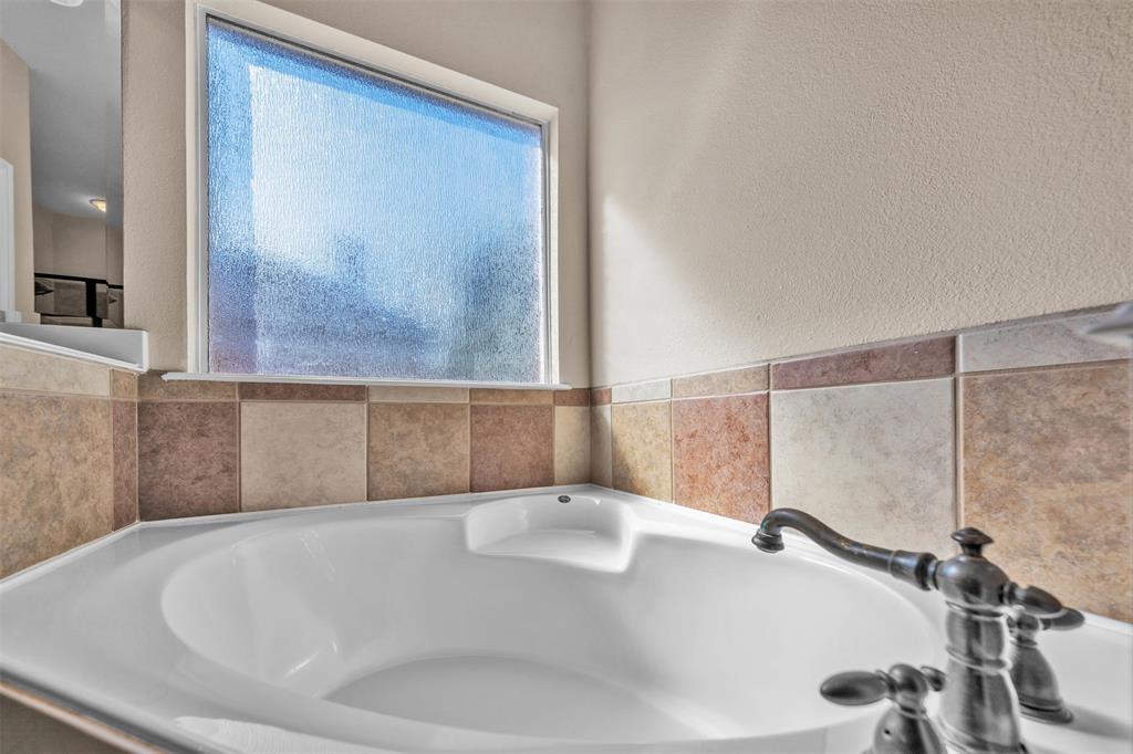 437 Rusty Run Drive Midlothian, TX 76065 - Photo 24 of 40 a bathroom with a tub and a shower