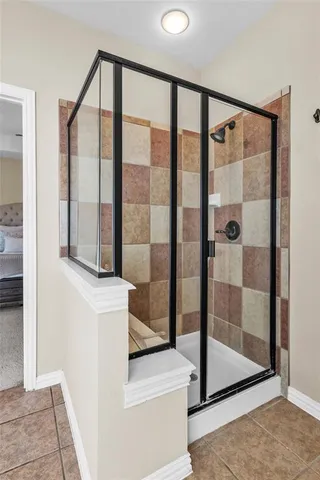 a bathroom with a glass shower door