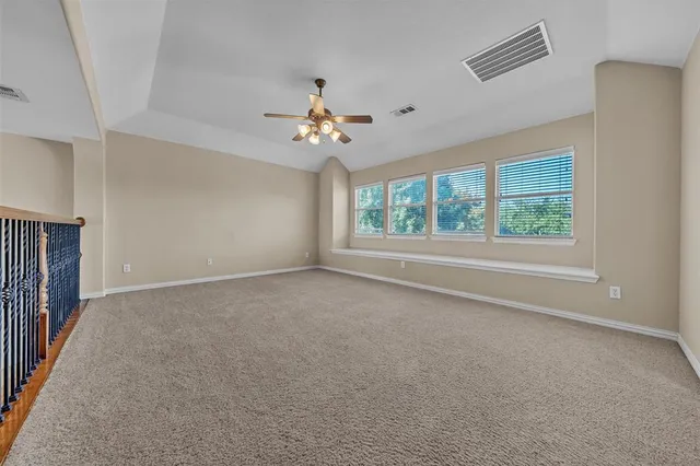 a view of room with a ceiling fan and window