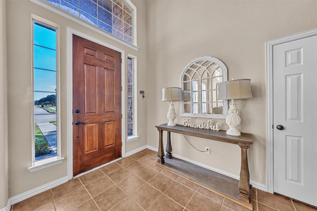 437 Rusty Run Drive Midlothian, TX 76065 - Photo 3 of 40 a view of washer and dryer with kitchen in the background