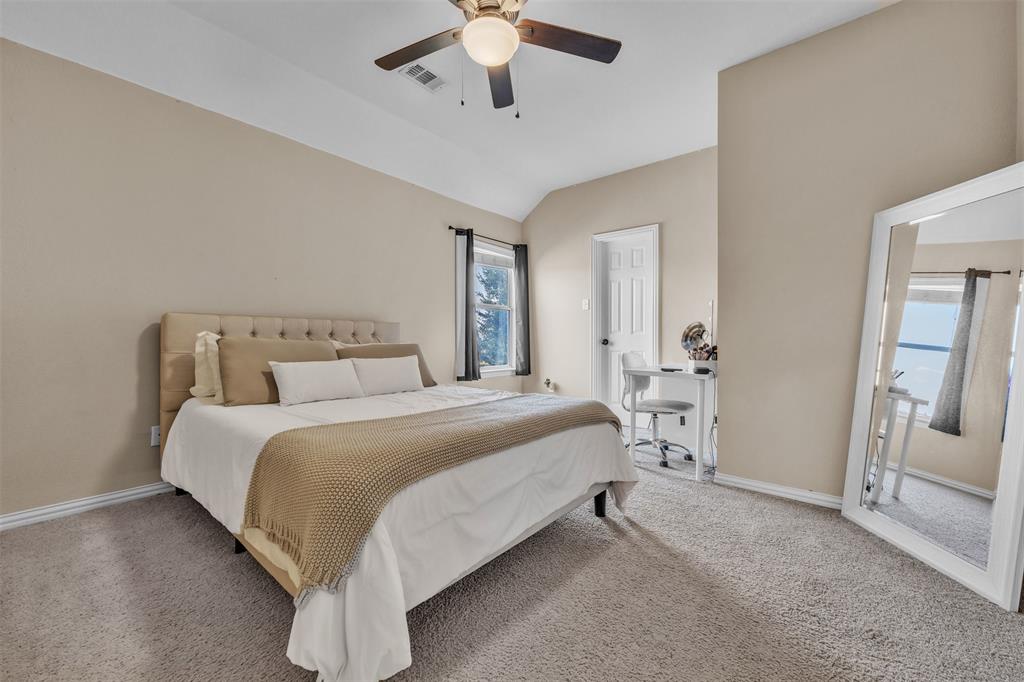 437 Rusty Run Drive Midlothian, TX 76065 - Photo 33 of 40 a bed room with a bed and a chandelier