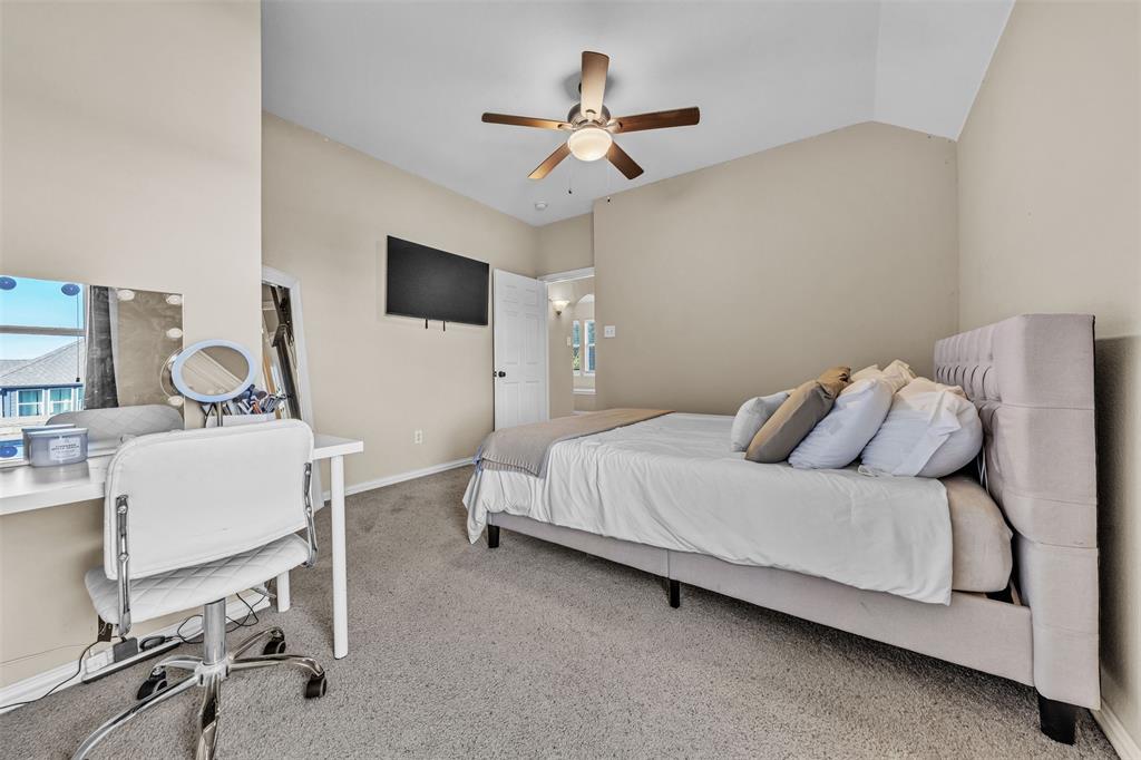 437 Rusty Run Drive Midlothian, TX 76065 - Photo 34 of 40 a bedroom with a bed and a flat screen tv