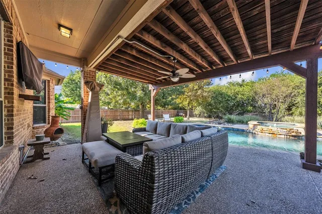 a view of porch with furniture and a yard