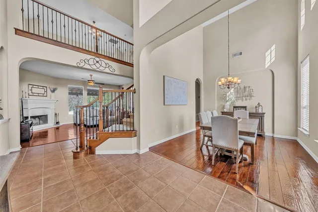 a view of a dining room with furniture wooden floor and a chandelier