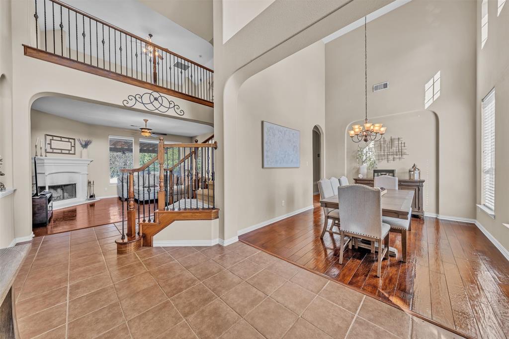 437 Rusty Run Drive Midlothian, TX 76065 - Photo 4 of 40 a view of a dining room with furniture wooden floor and a chandelier
