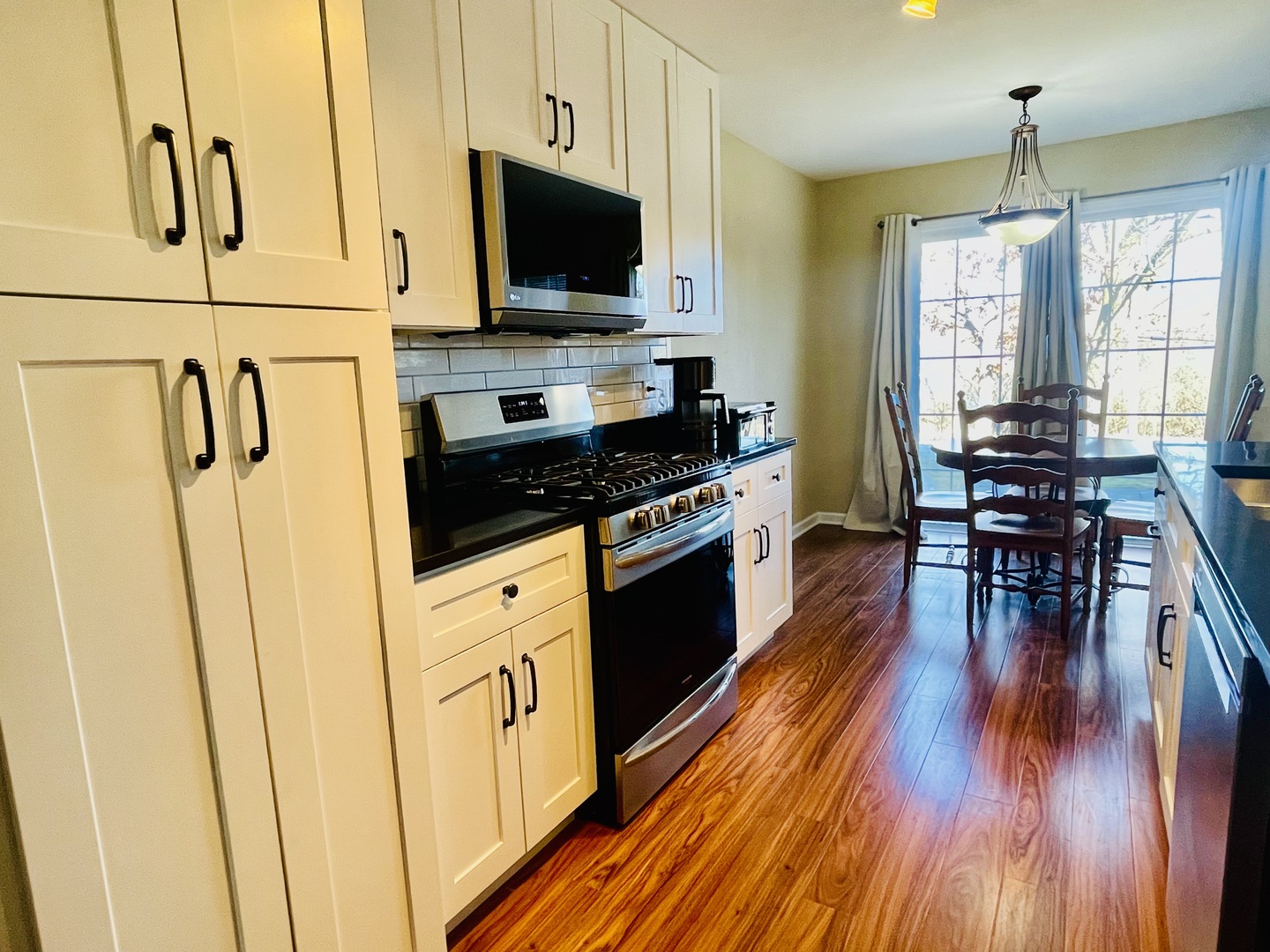 34718 Lakeside Drive Ingleside, IL 60041 - Photo 8 of 34 a kitchen with stainless steel appliances a stove a sink a microwave and wooden floors
