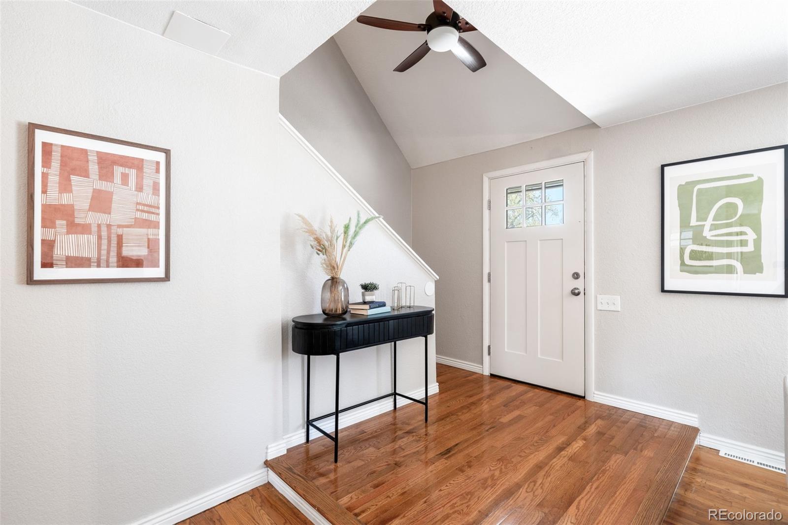 7186 West 79th Drive Arvada, CO 80003 - Photo 11 of 43 a view of a hallway with wooden floor and windows