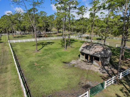 a spacious bedroom with a bed and a flat tv screen on a dresser