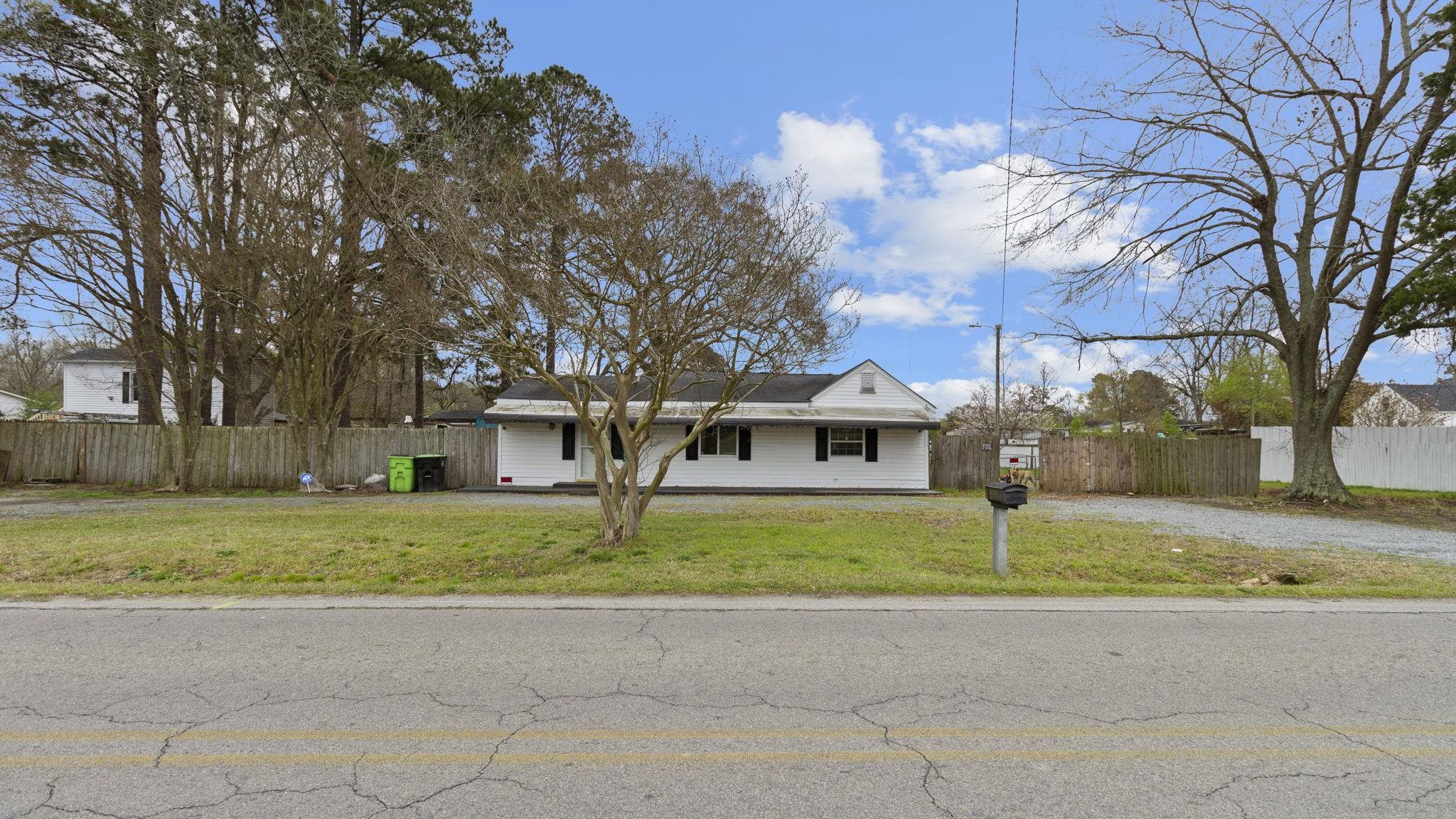 a house that has a tree in front of it
