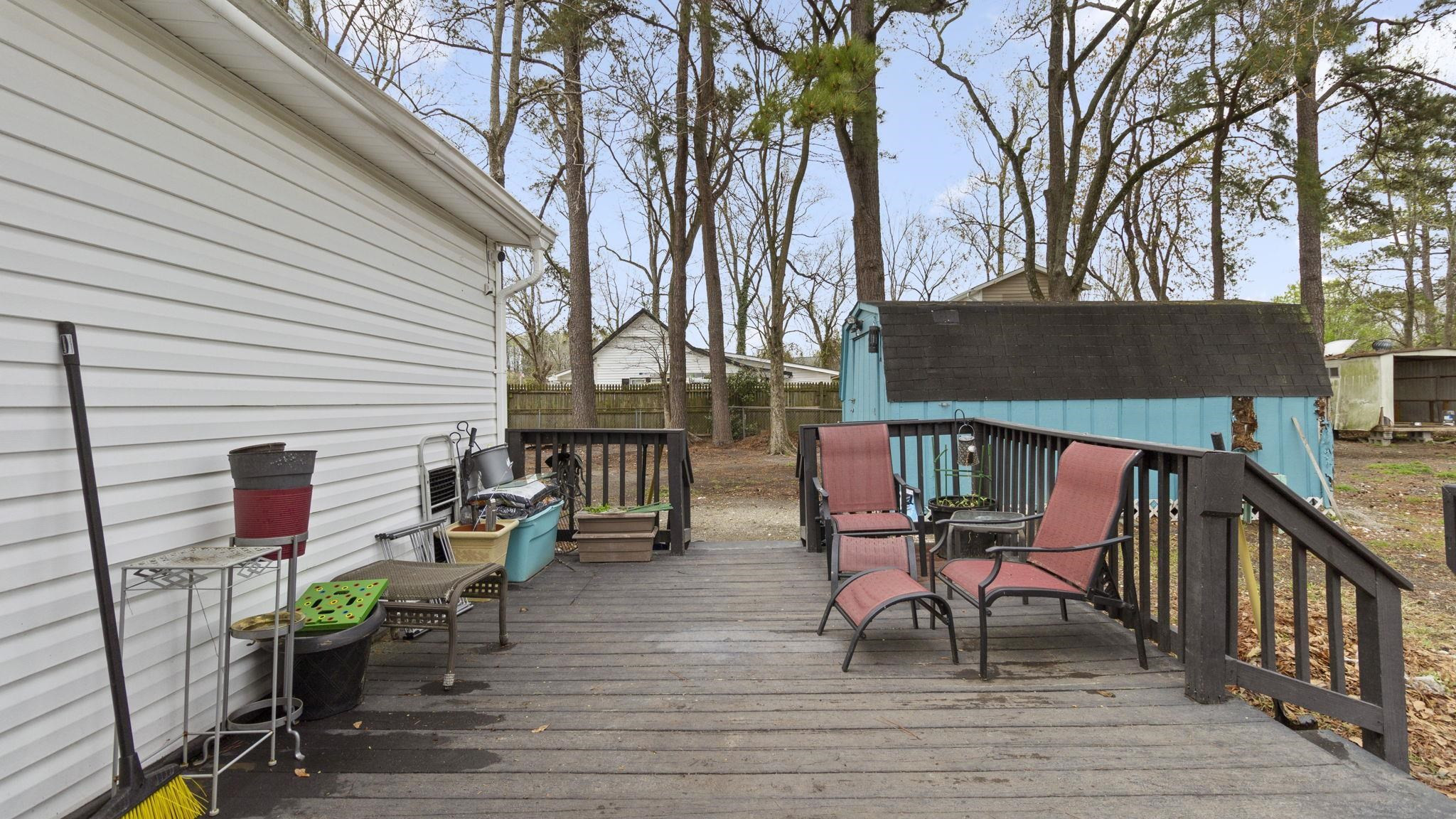 103 St Matthews Road Erwin, NC 28339 - Photo 12 of 14 a roof deck with table and chairs potted plants and wooden floor
