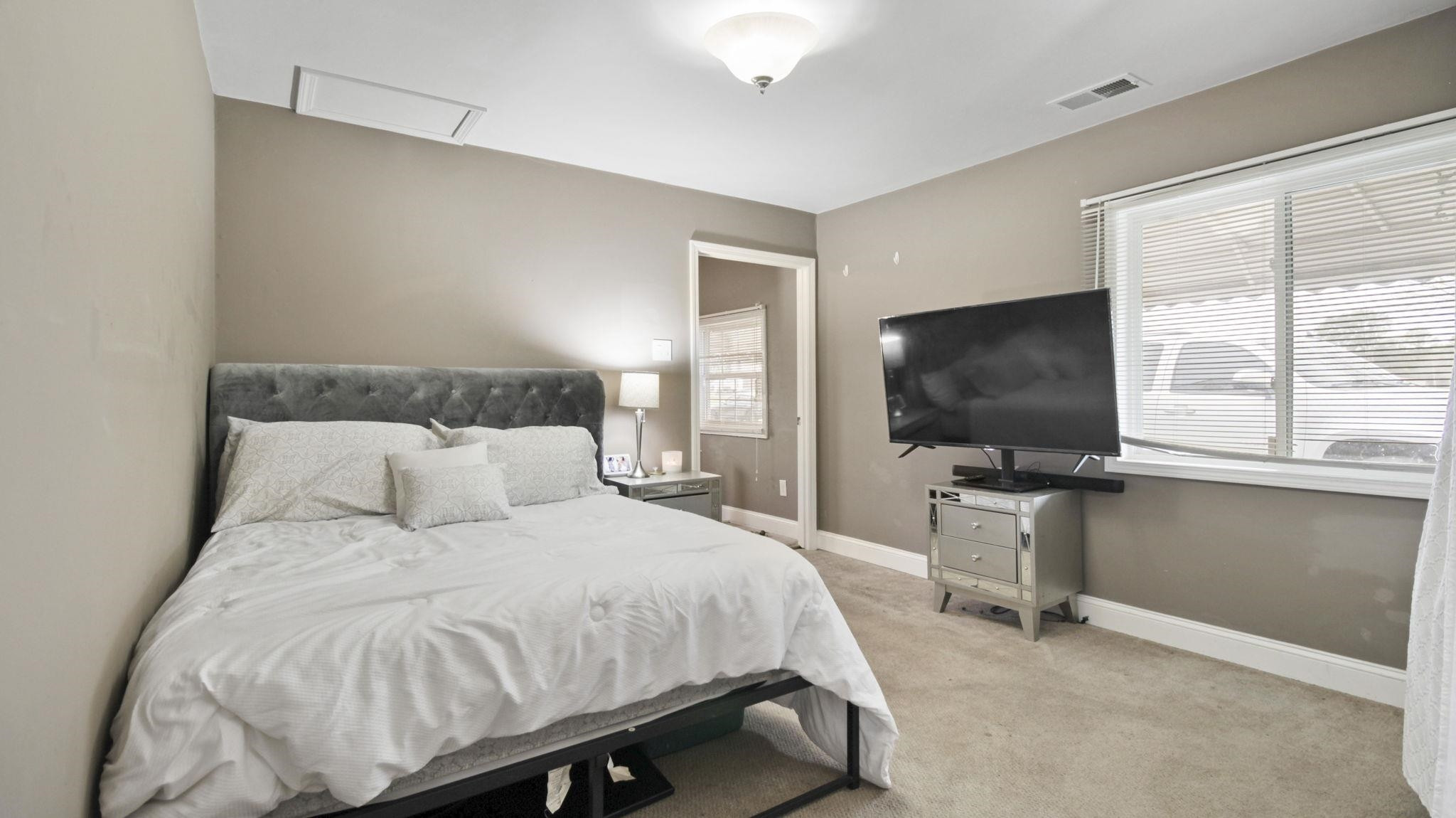 103 St Matthews Road Erwin, NC 28339 - Photo 10 of 14 a bedroom with a bed and a flat screen tv