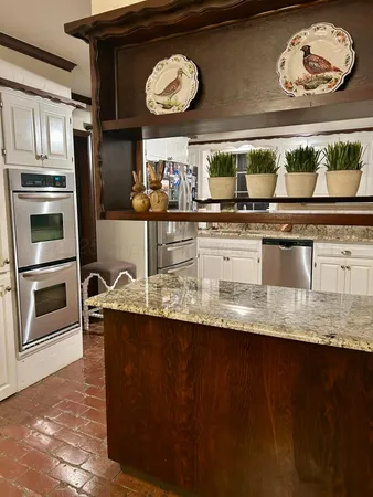 a kitchen with stainless steel appliances granite countertop a stove and a microwave