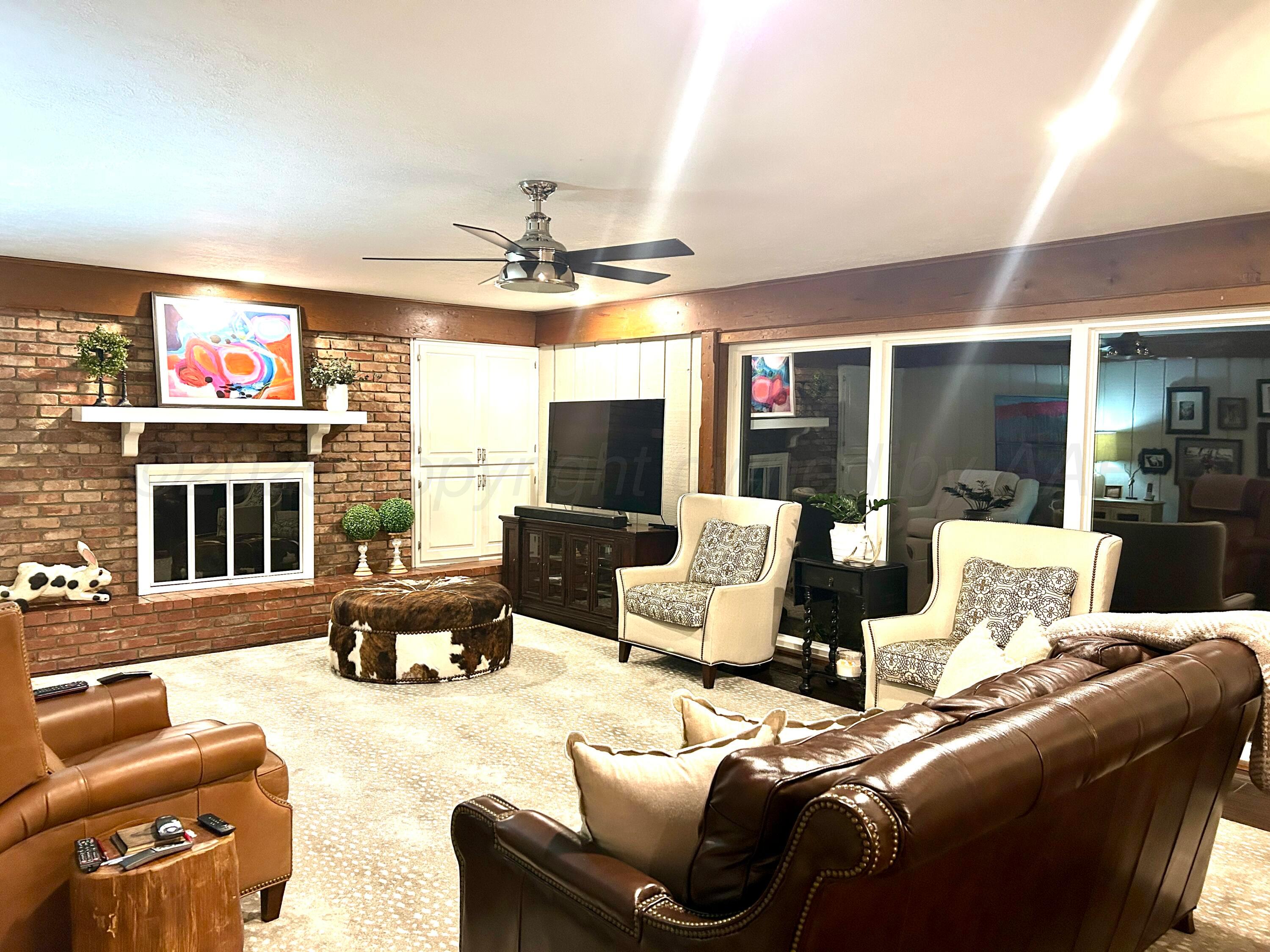 201 East 4th Street Higgins, TX 79046 - Photo 12 of 27 a living room with furniture and a flat screen tv