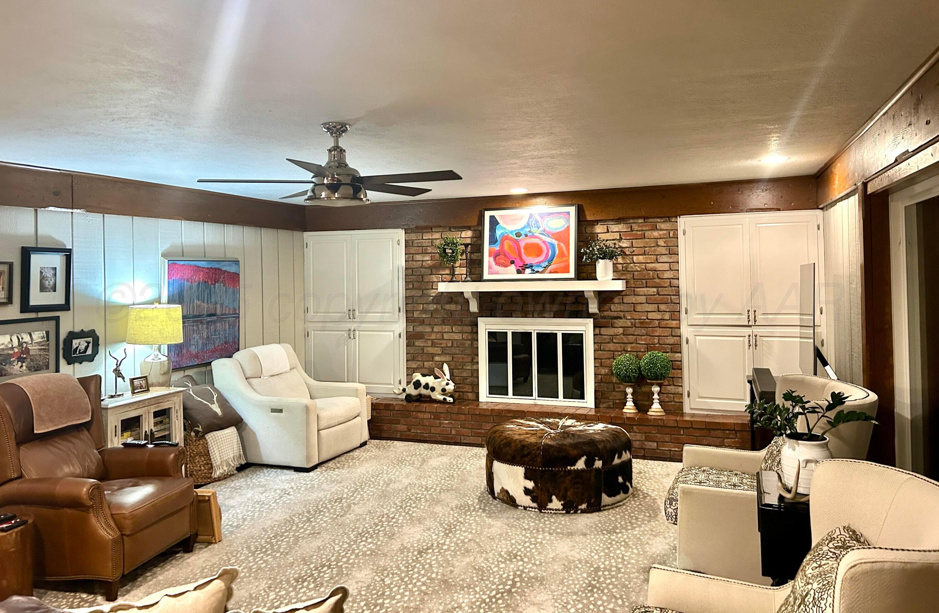 201 East 4th Street Higgins, TX 79046 - Photo 13 of 27 a living room with furniture a fireplace and a flat screen tv