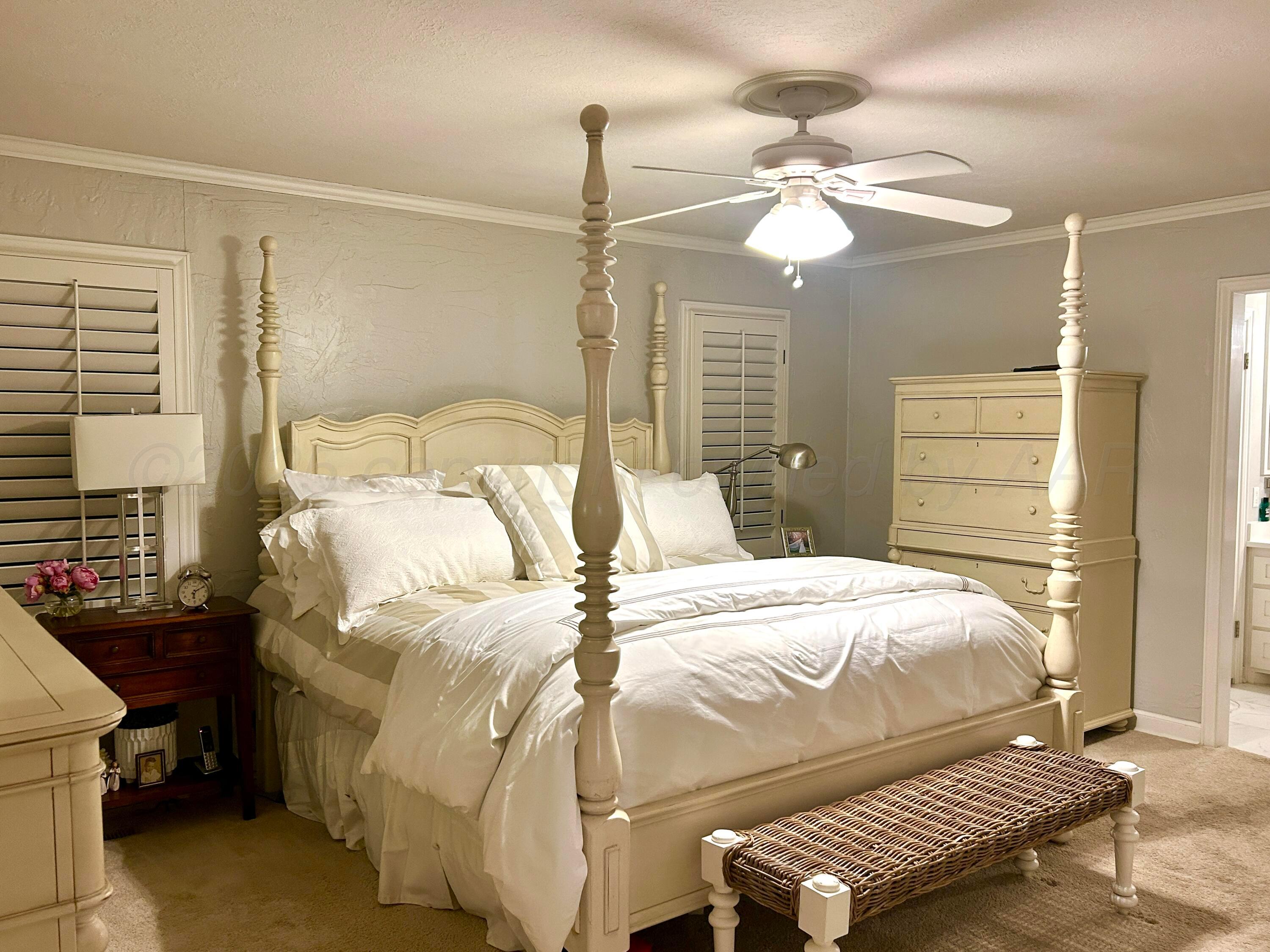 201 East 4th Street Higgins, TX 79046 - Photo 16 of 27 a bedroom with a bed and a chandelier
