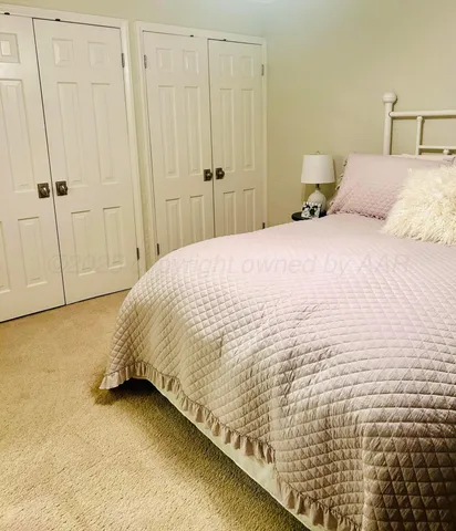 a bedroom with a bed and curtain