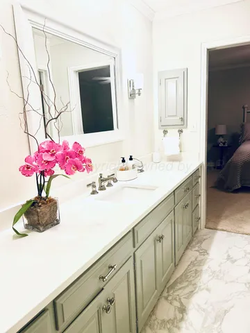 a bathroom with a sink vanity and mirror
