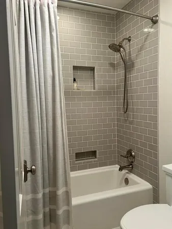 a bathroom with a bathtub and a shower