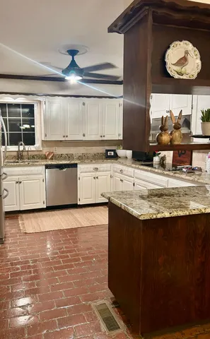 a kitchen with stainless steel appliances granite countertop a sink stove and cabinets