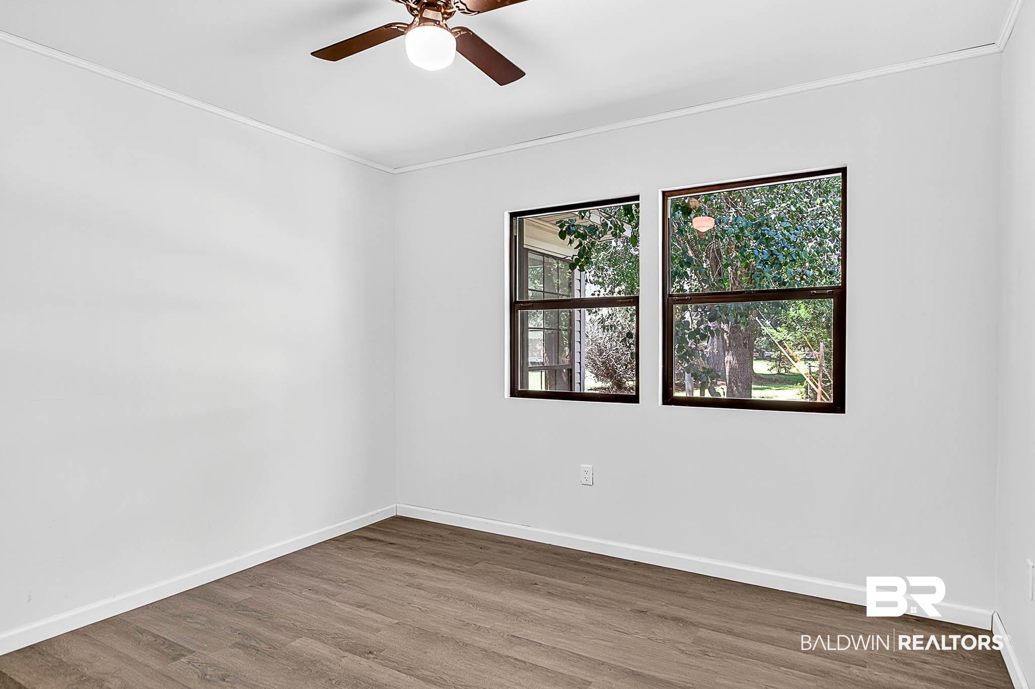 101 Terry Avenue Brewton, AL 36426 - Photo 42 of 48 Empty room featuring ornamental molding, wood finished floors, and ceiling fan