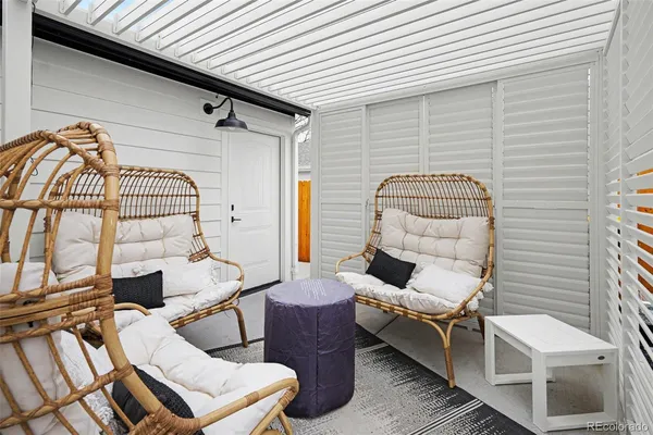a view of a chairs and table in the balcony