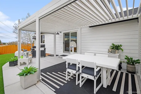 a view of a patio with table and chairs with potted plants