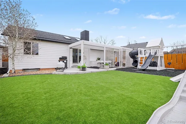 a front view of a house with garden and a sitting area