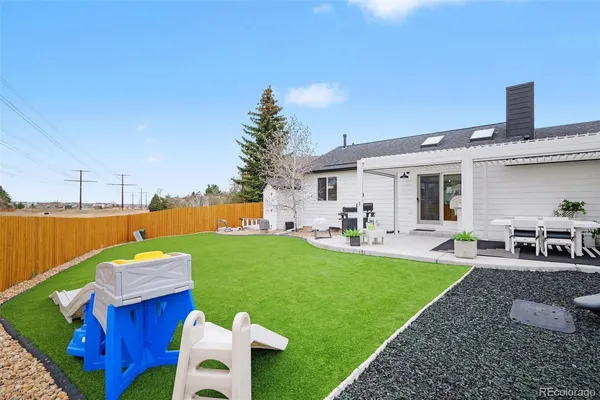 a view of a house with backyard porch and furniture