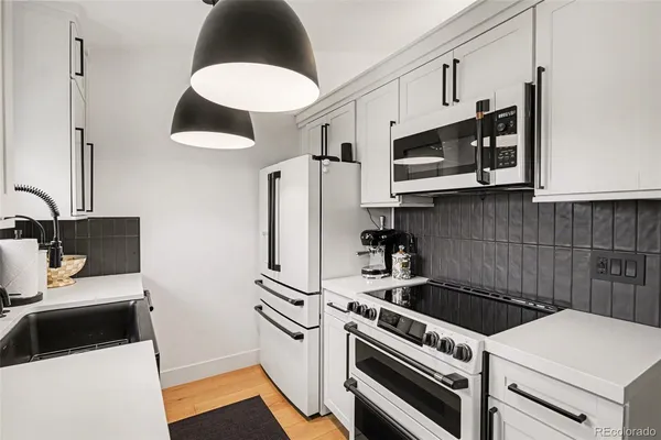 a kitchen with stainless steel appliances a stove a microwave and a refrigerator