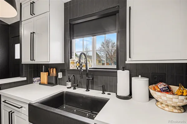 a kitchen with a sink and a stove top oven