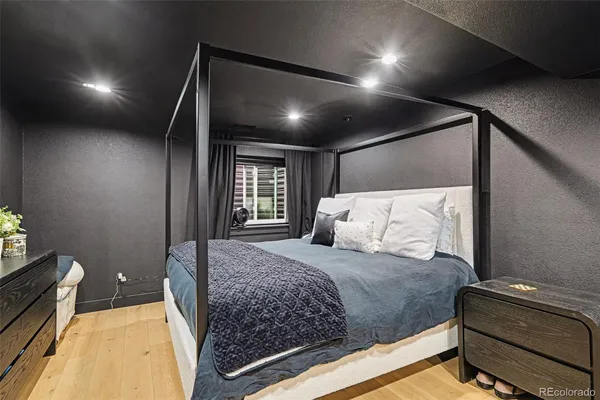 a bedroom with a bed window and couch