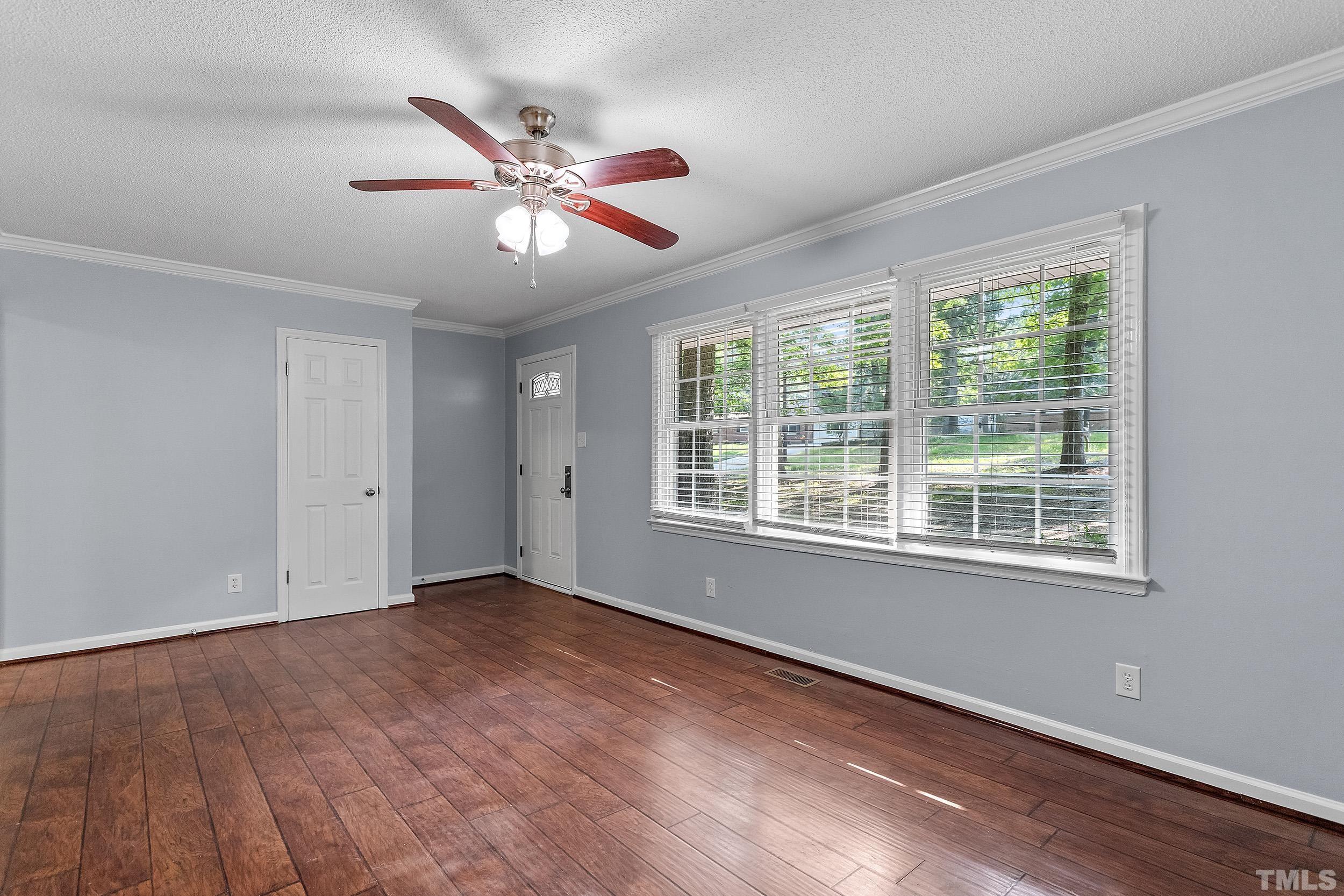2921 Darrow Road Durham, NC 27704 - Photo 11 of 32 a view of an empty room with wooden floor and a window
