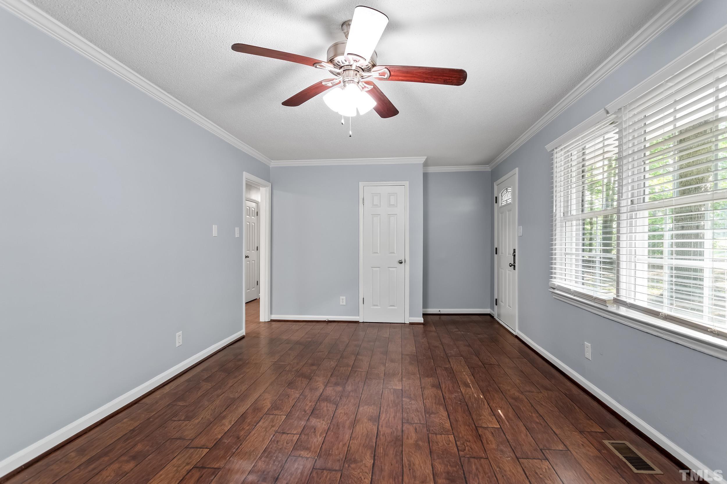 2921 Darrow Road Durham, NC 27704 - Photo 13 of 32 a view of an empty room with wooden floor and a window