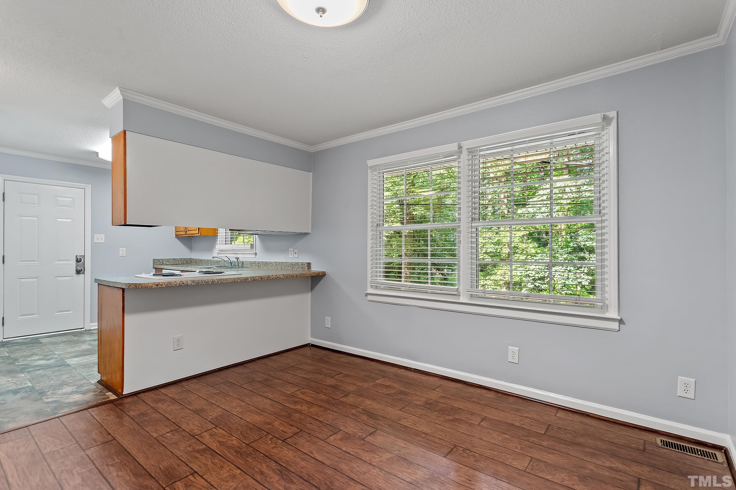 2921 Darrow Road Durham, NC 27704 - Photo 14 of 32 a room with a wooden floor and window