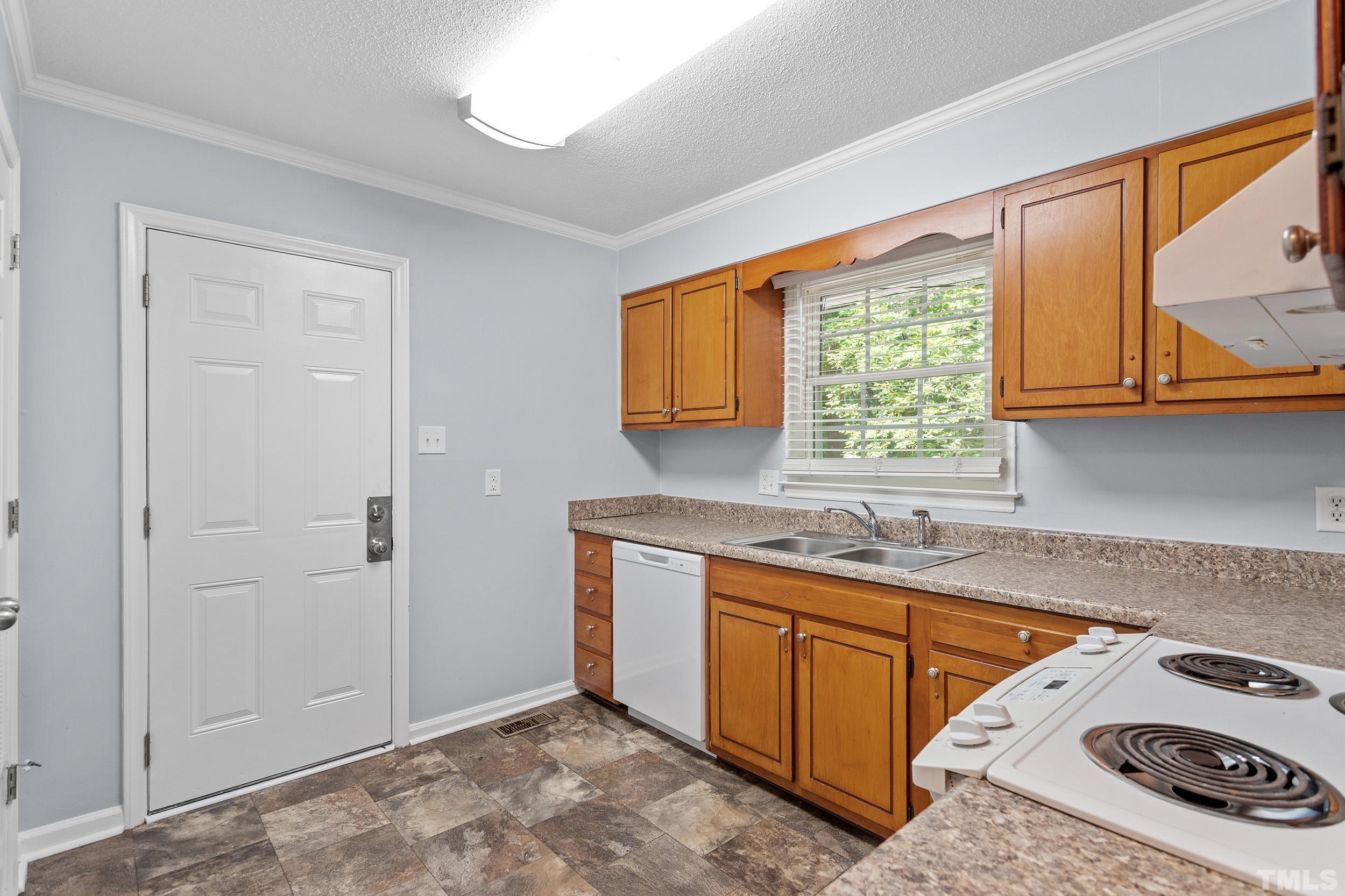 2921 Darrow Road Durham, NC 27704 - Photo 17 of 32 a kitchen that has a sink a stove and a window