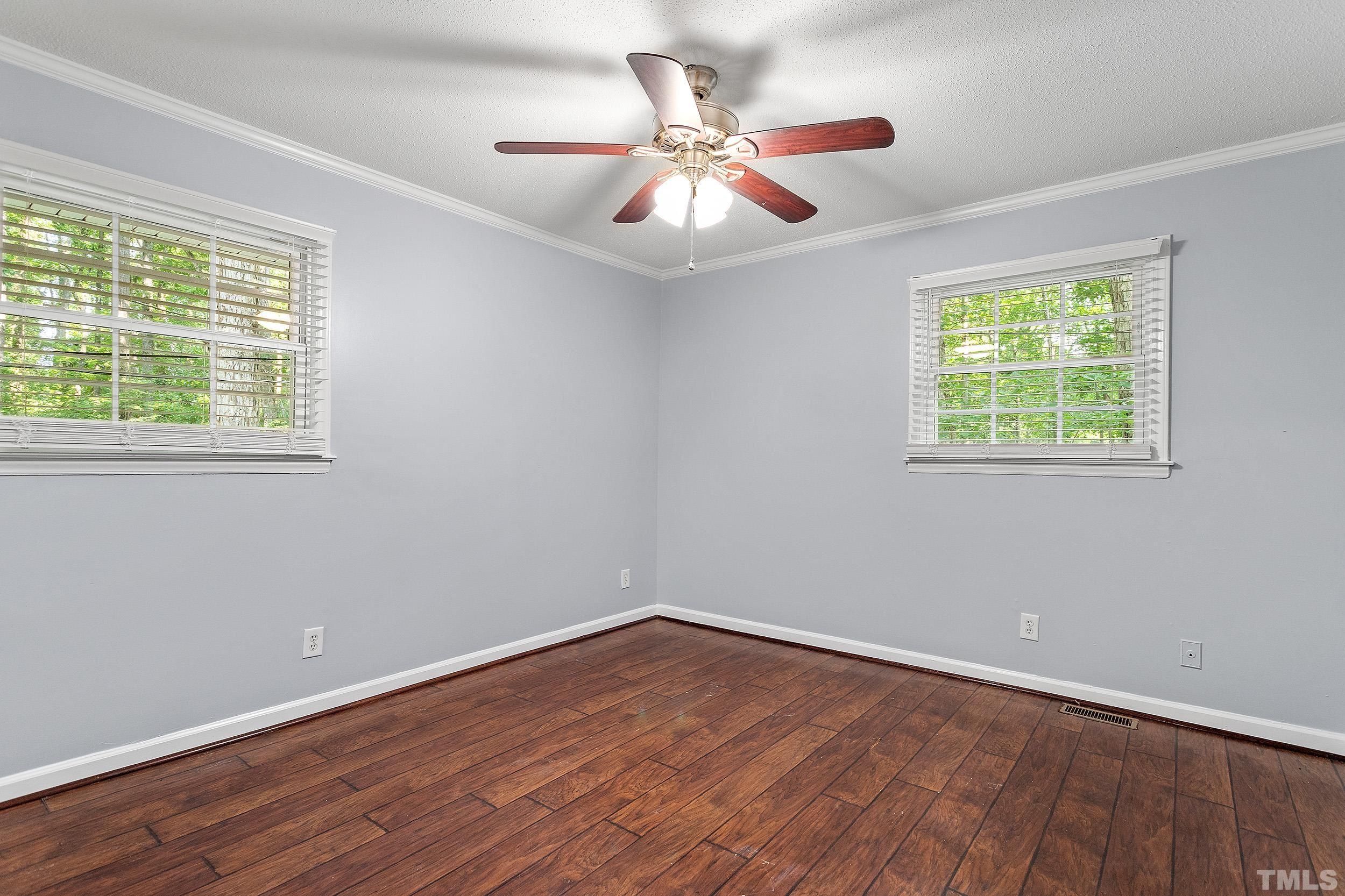 2921 Darrow Road Durham, NC 27704 - Photo 21 of 32 a view of an empty room with wooden floor and a window