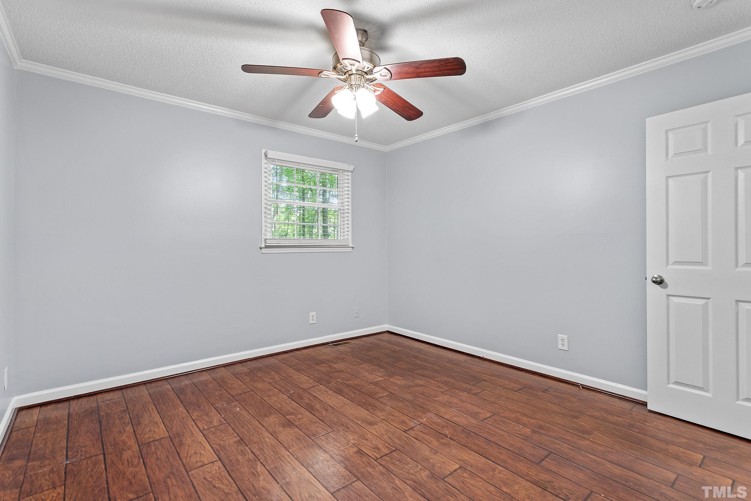 2921 Darrow Road Durham, NC 27704 - Photo 24 of 32 wooden floor in an empty room with a window