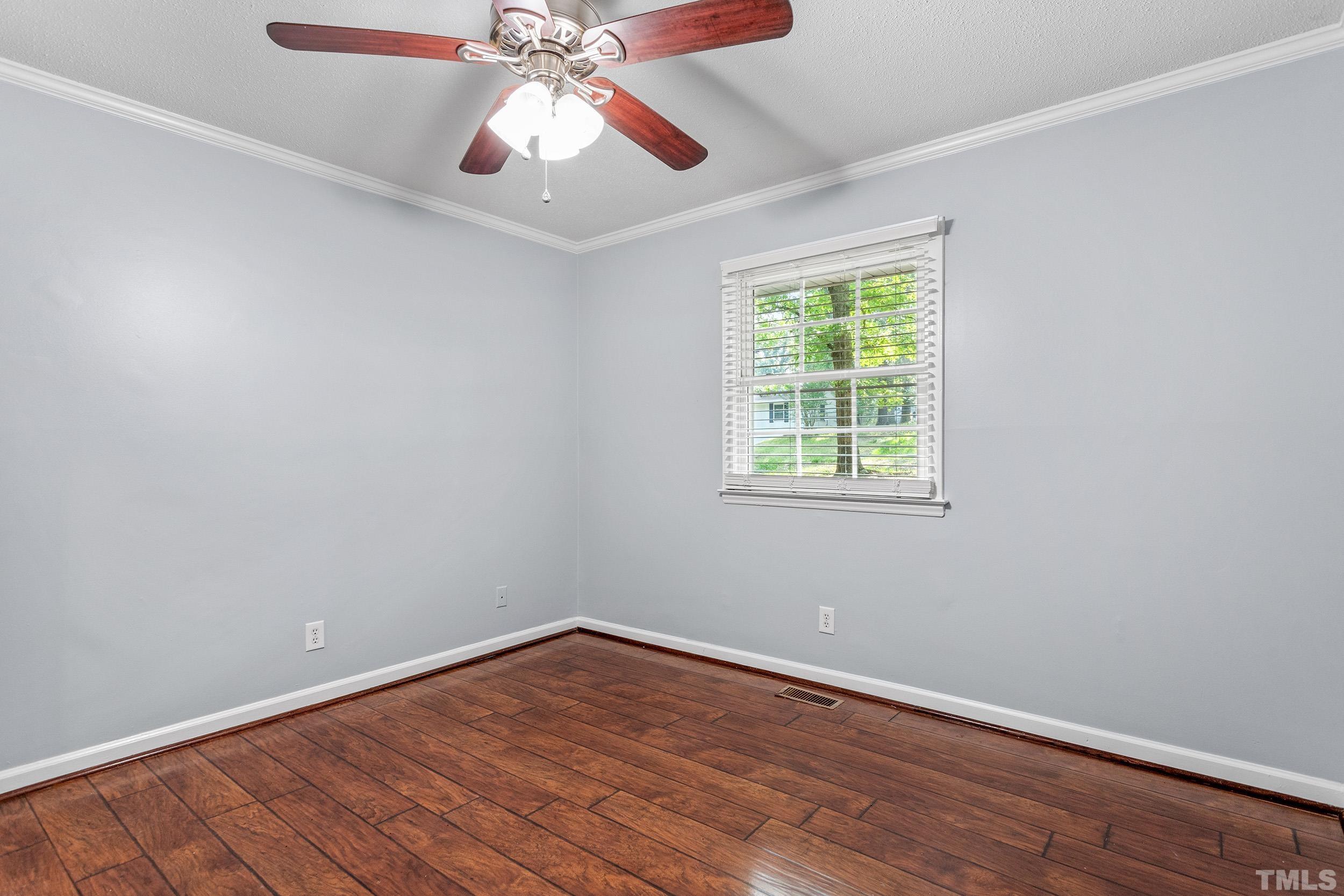 2921 Darrow Road Durham, NC 27704 - Photo 27 of 32 a view of an empty room with wooden floor and a window