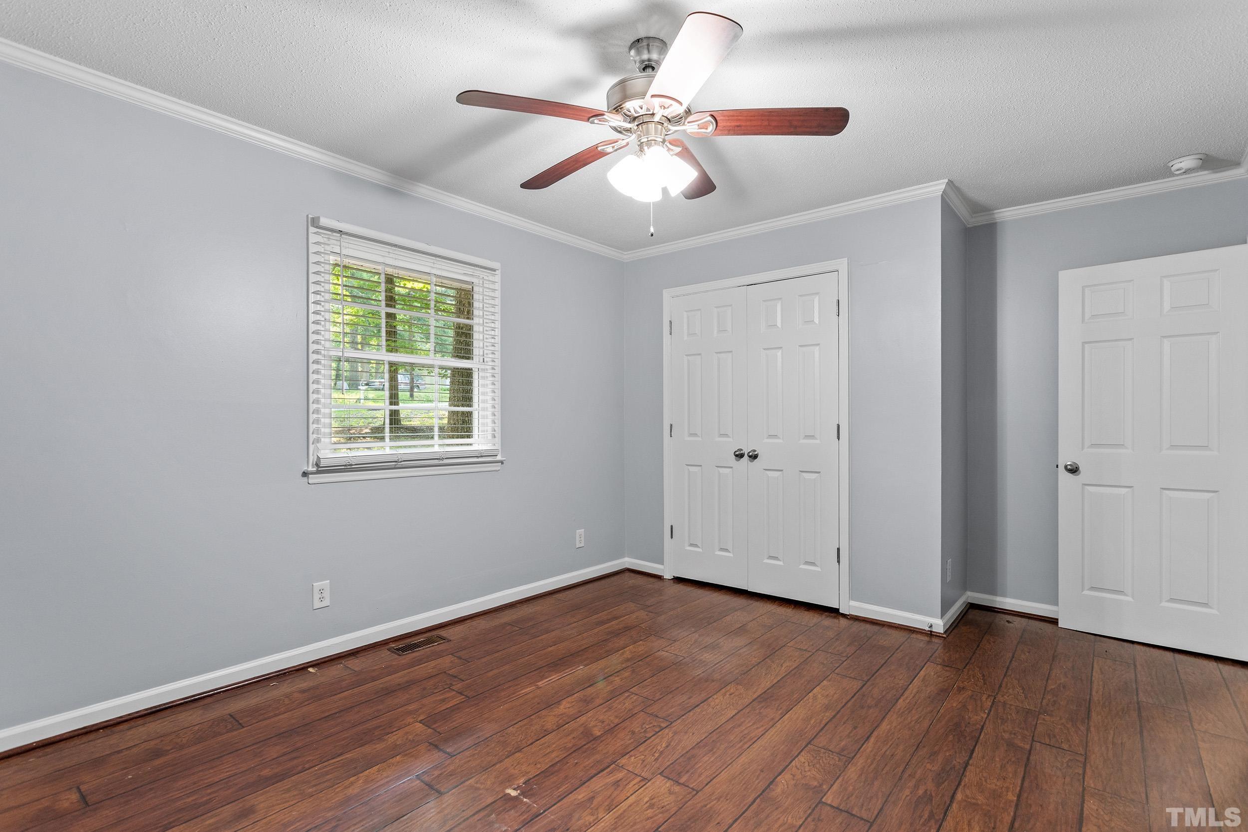 2921 Darrow Road Durham, NC 27704 - Photo 30 of 32 a view of an empty room with wooden floor and a window