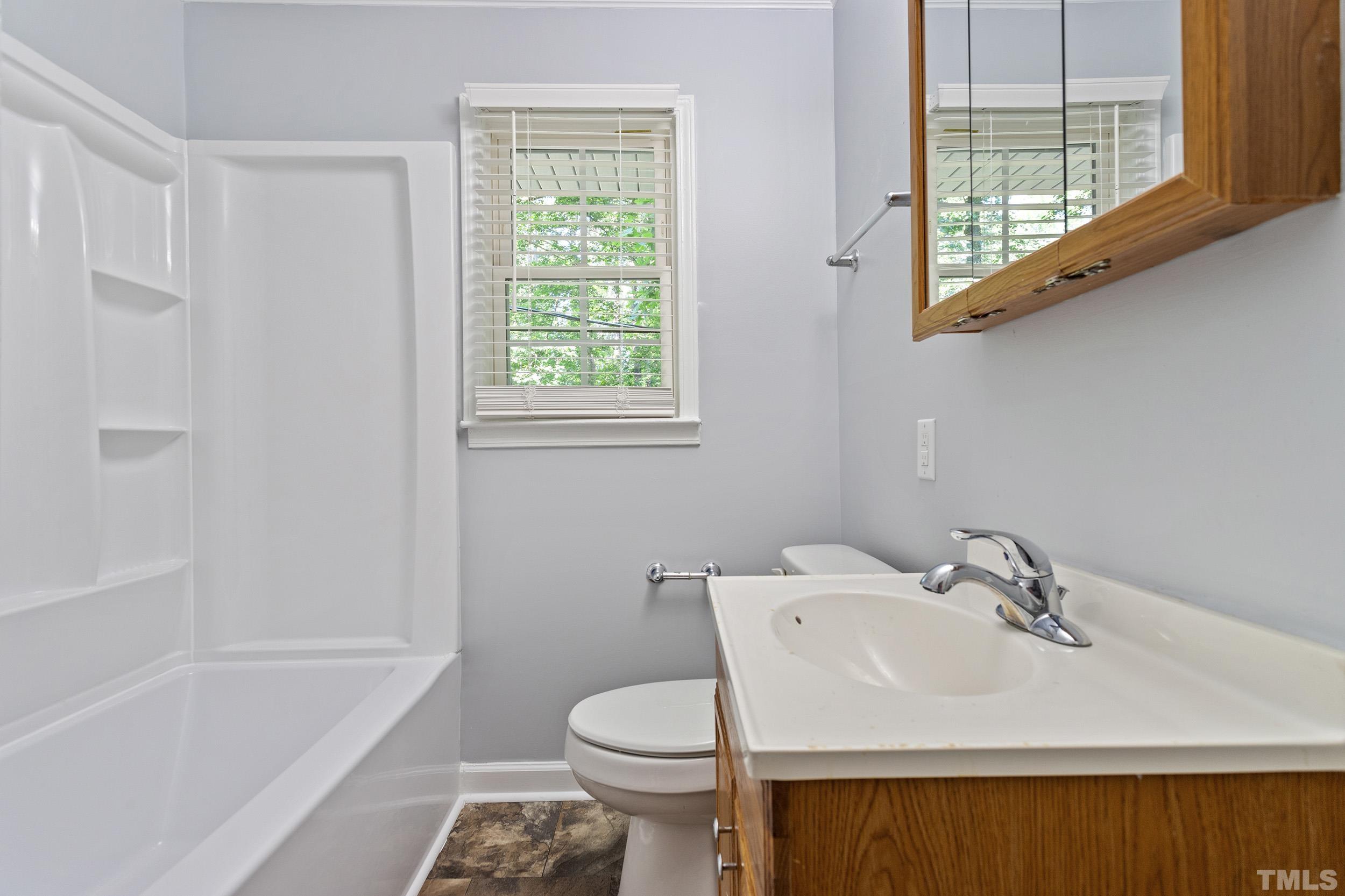 2921 Darrow Road Durham, NC 27704 - Photo 32 of 32 a bathroom with a sink toilet and bathtub
