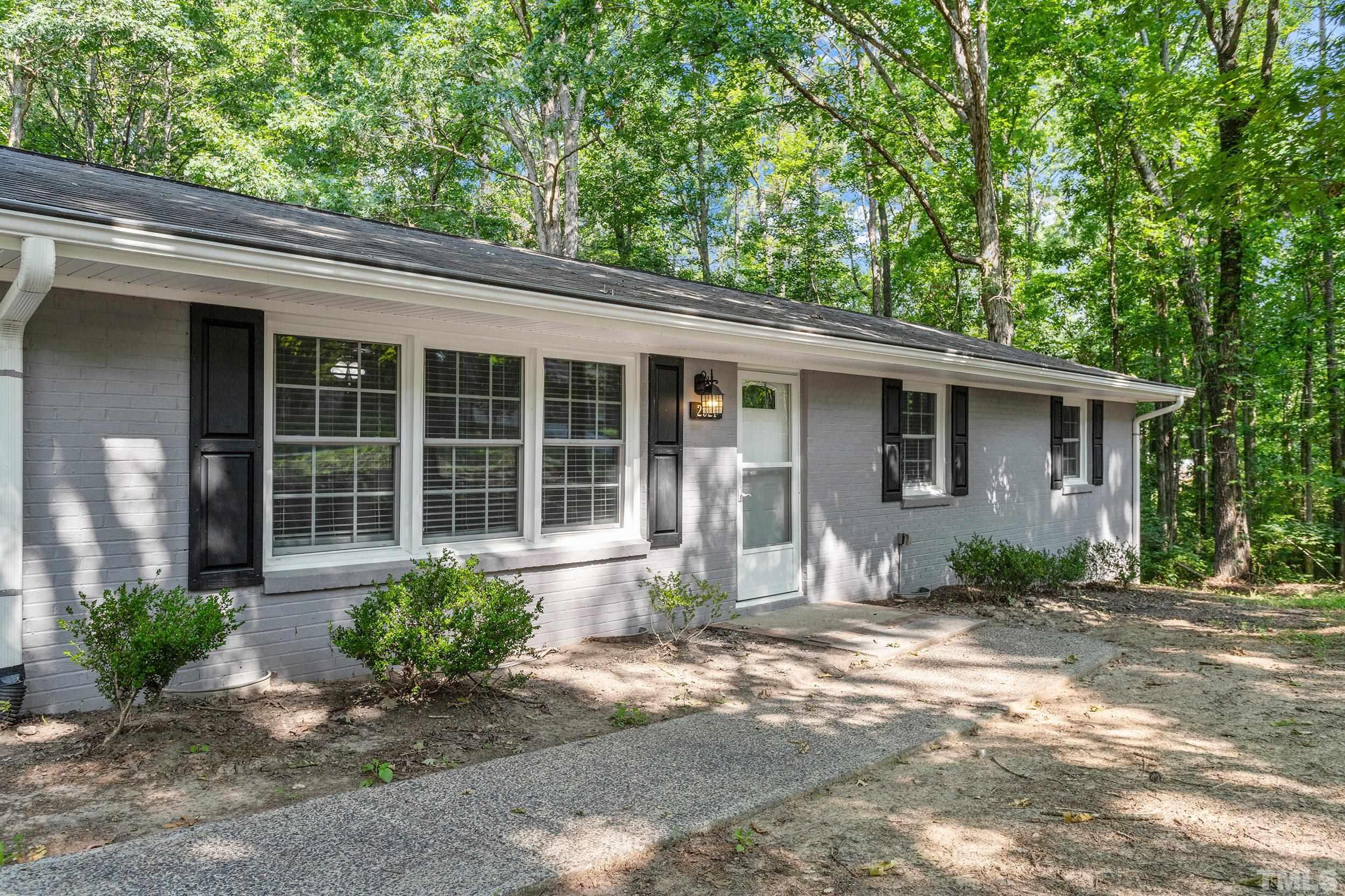 2921 Darrow Road Durham, NC 27704 - Photo 4 of 32 a front view of a house with garden