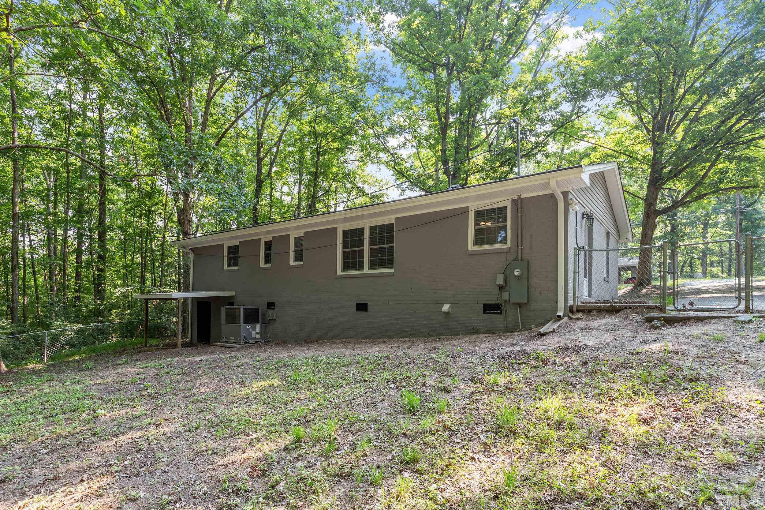 2921 Darrow Road Durham, NC 27704 - Photo 6 of 32 a view of a house with a yard and large tree