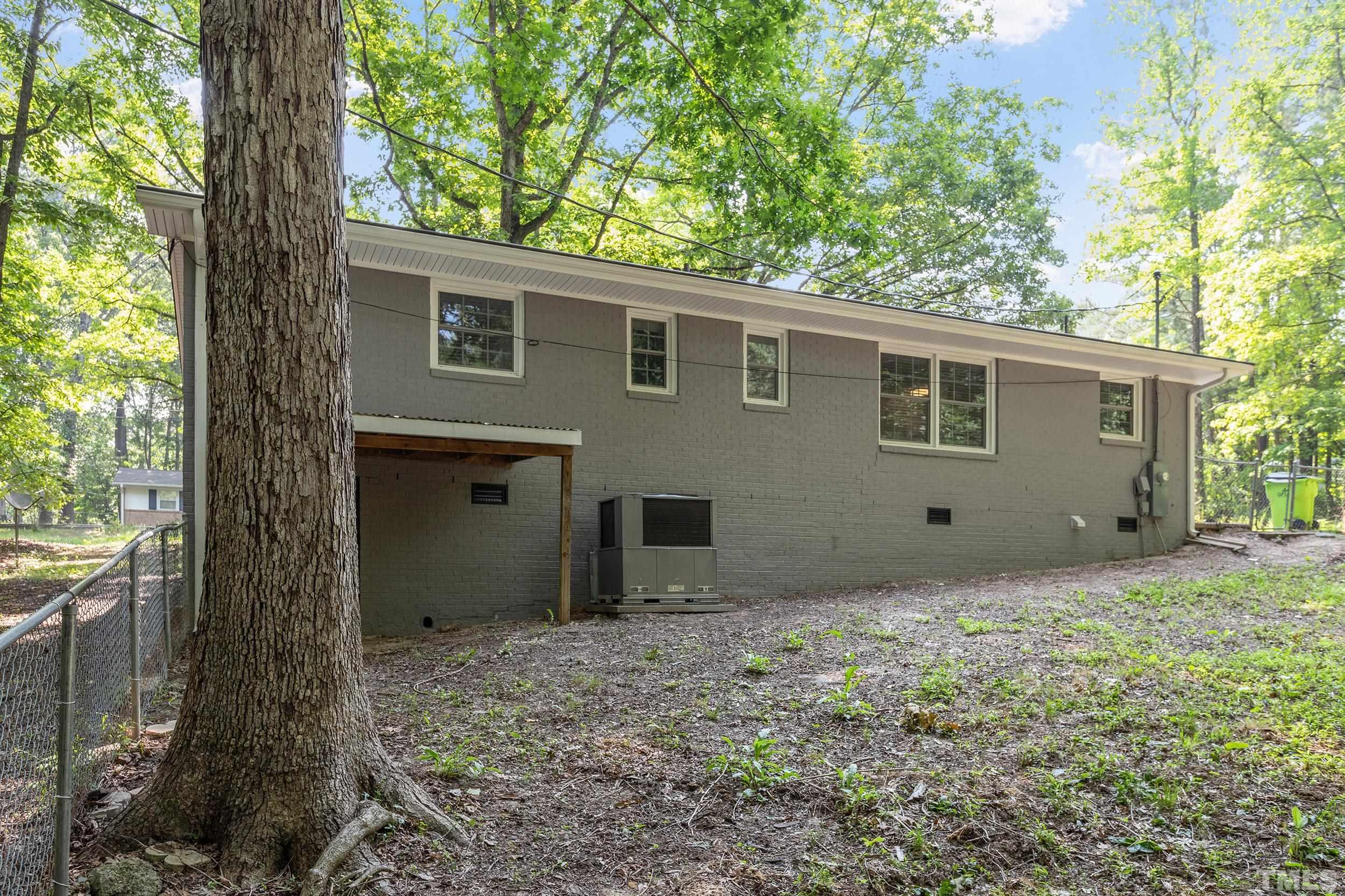 2921 Darrow Road Durham, NC 27704 - Photo 8 of 32 a view of a house with a yard and large tree