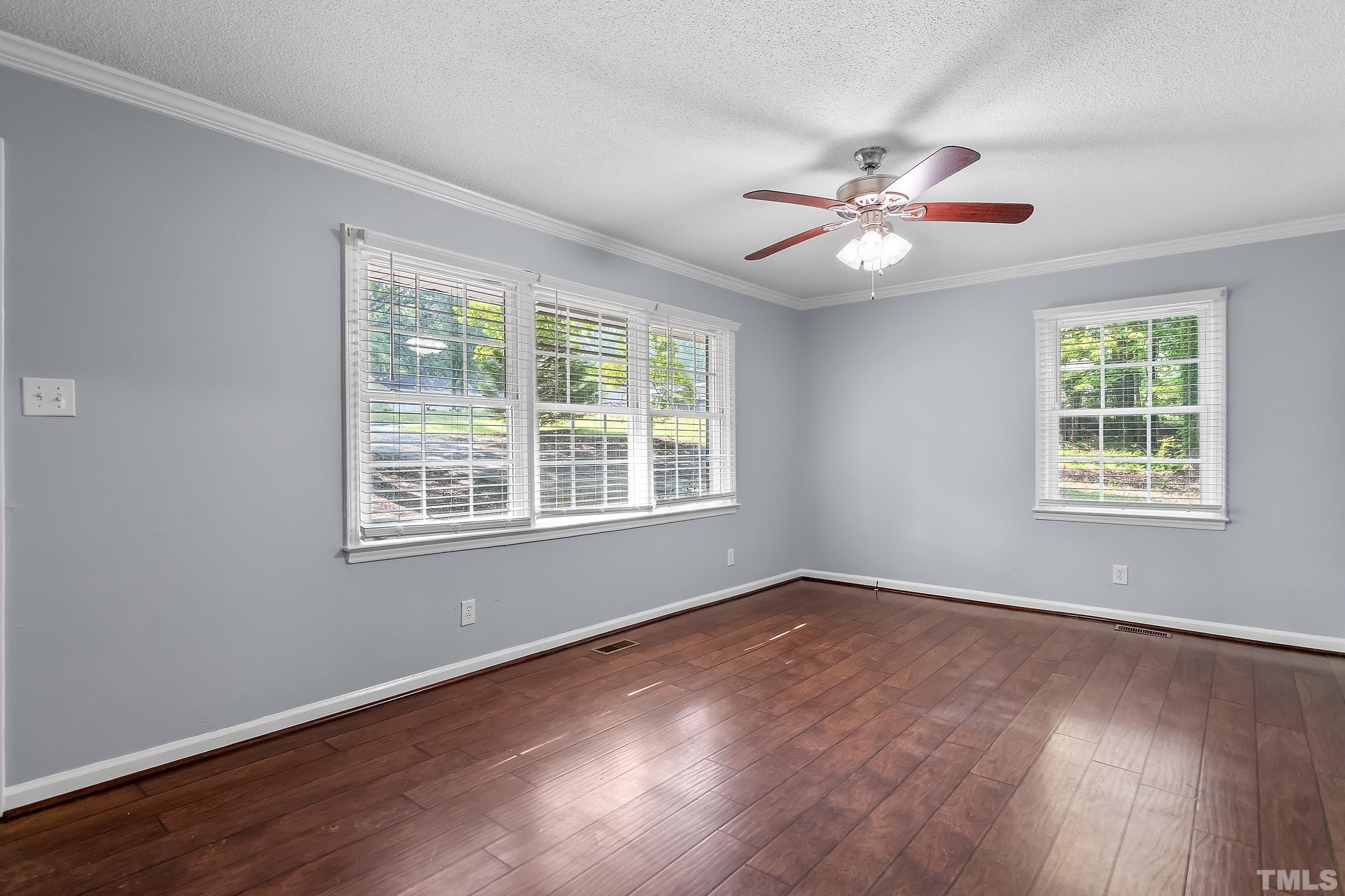 2921 Darrow Road Durham, NC 27704 - Photo 10 of 32 a view of an empty room with wooden floor and a window