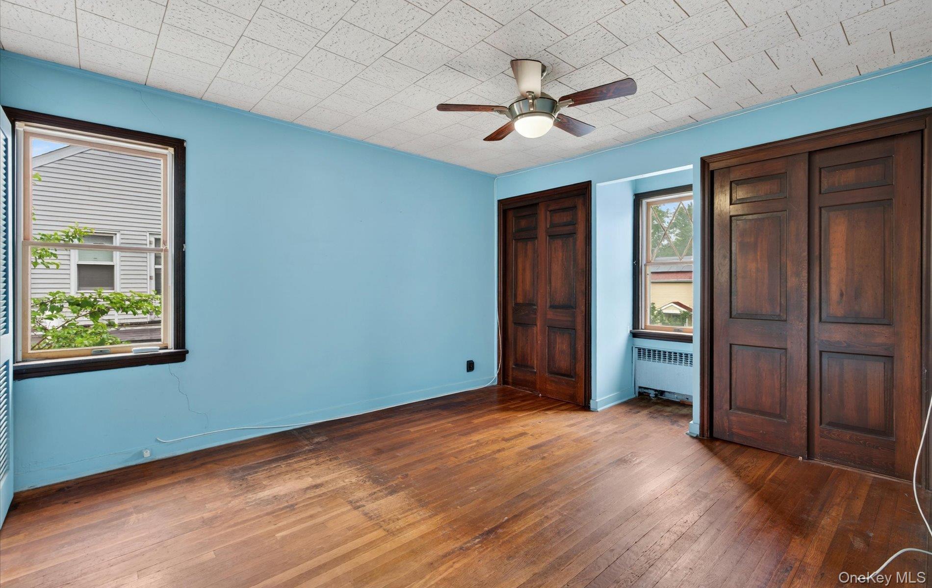 24 Purdue Road Glen Cove, NY 11542 - Photo 29 of 41 an empty room with wooden floor closet and windows