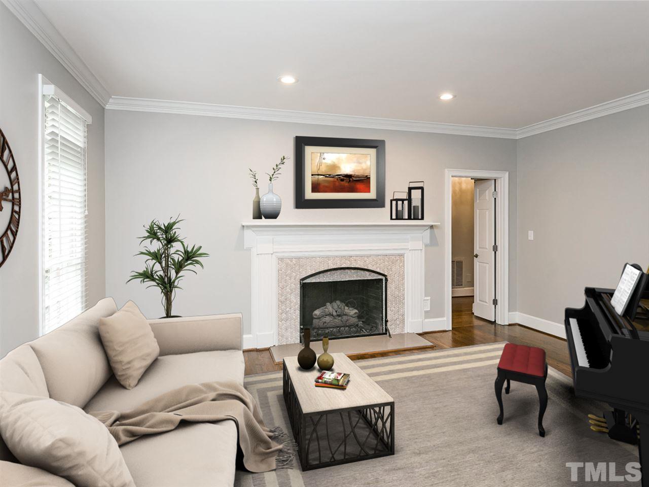 4038 John S Raboteau Wynd Raleigh, NC 27612 - Photo 3 of 25 a living room with furniture and a fireplace