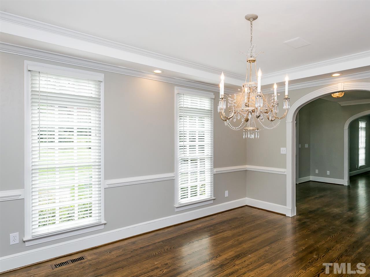 4038 John S Raboteau Wynd Raleigh, NC 27612 - Photo 5 of 25 a view of a room with wooden floor chandelier and windows